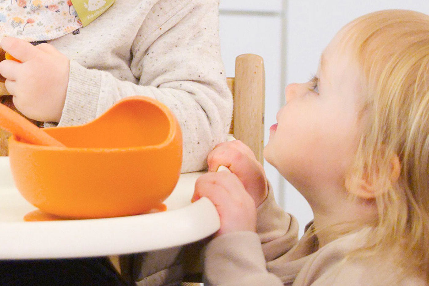 Quark Baby orange bowl with wooden spoon, baby-led weaning feeding setup