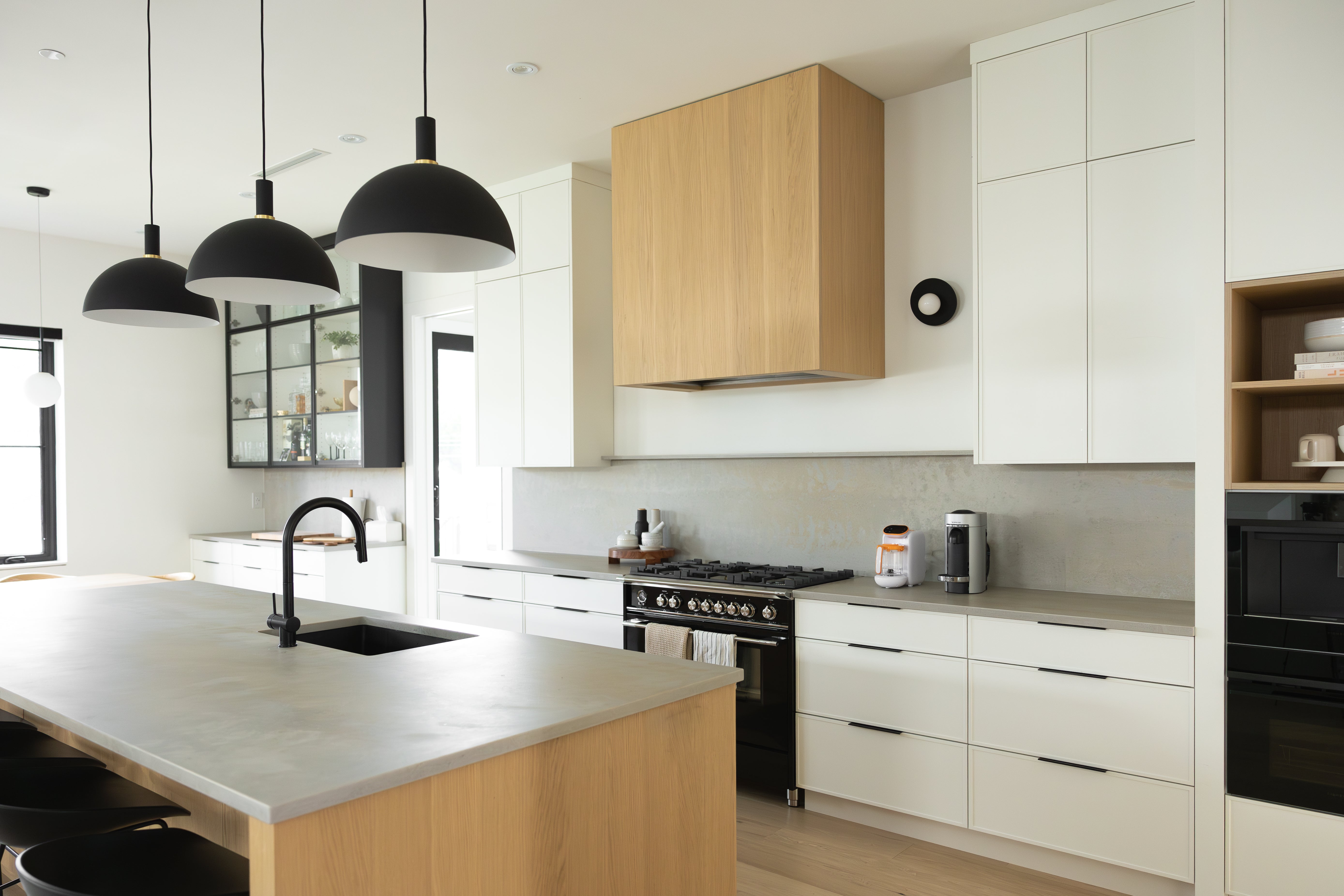 Modern kitchen with organized storage and clean countertops for busy parents using Quark Baby solutions