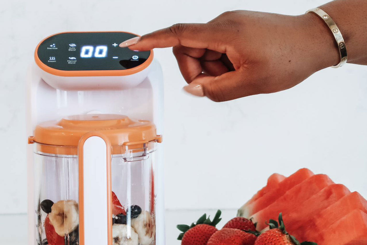 Quark Baby blender with fresh strawberries and blueberries for homemade baby food preparation