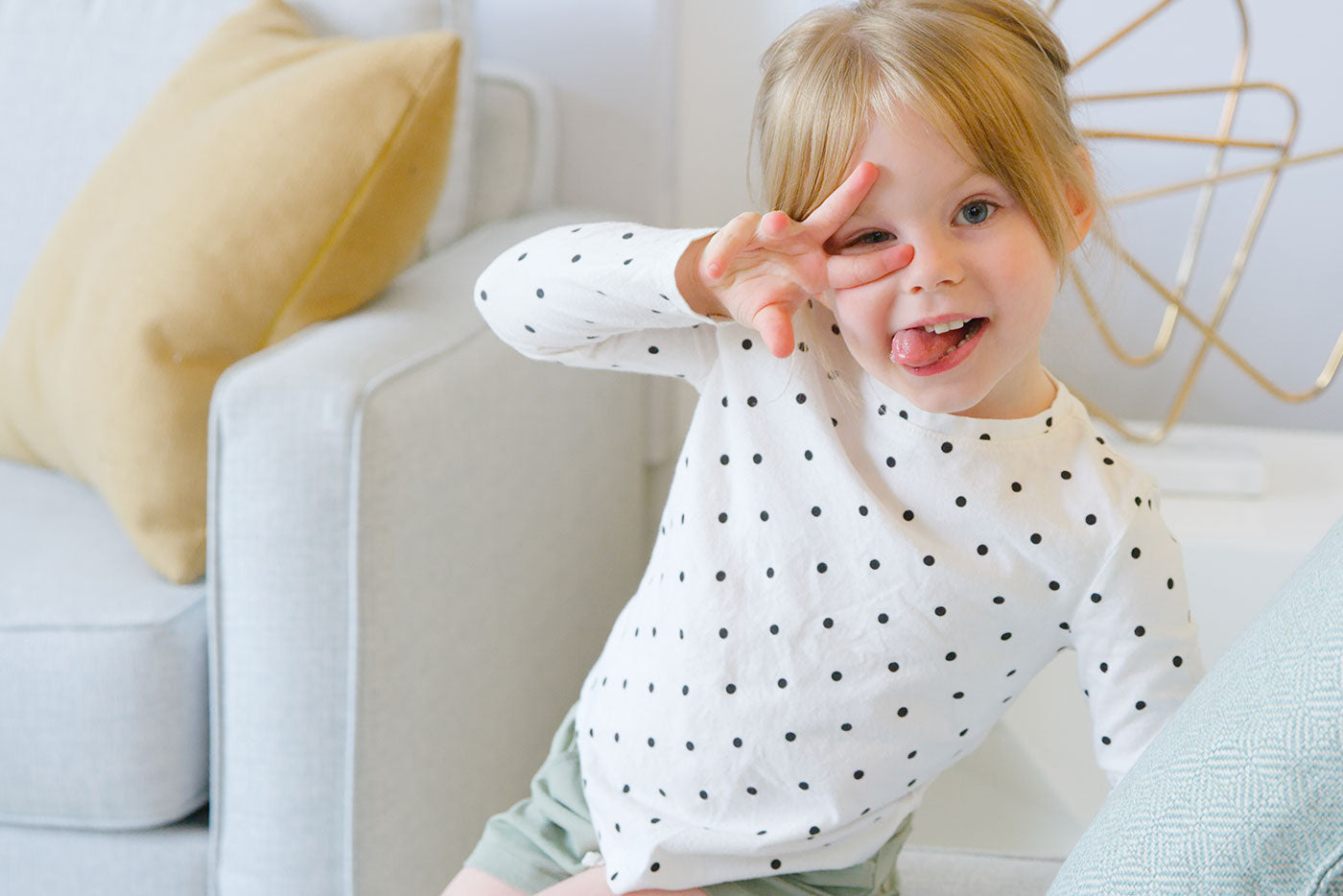 Toddler in polka-dot shirt smiling during playtime, Quark Baby lifestyle moment