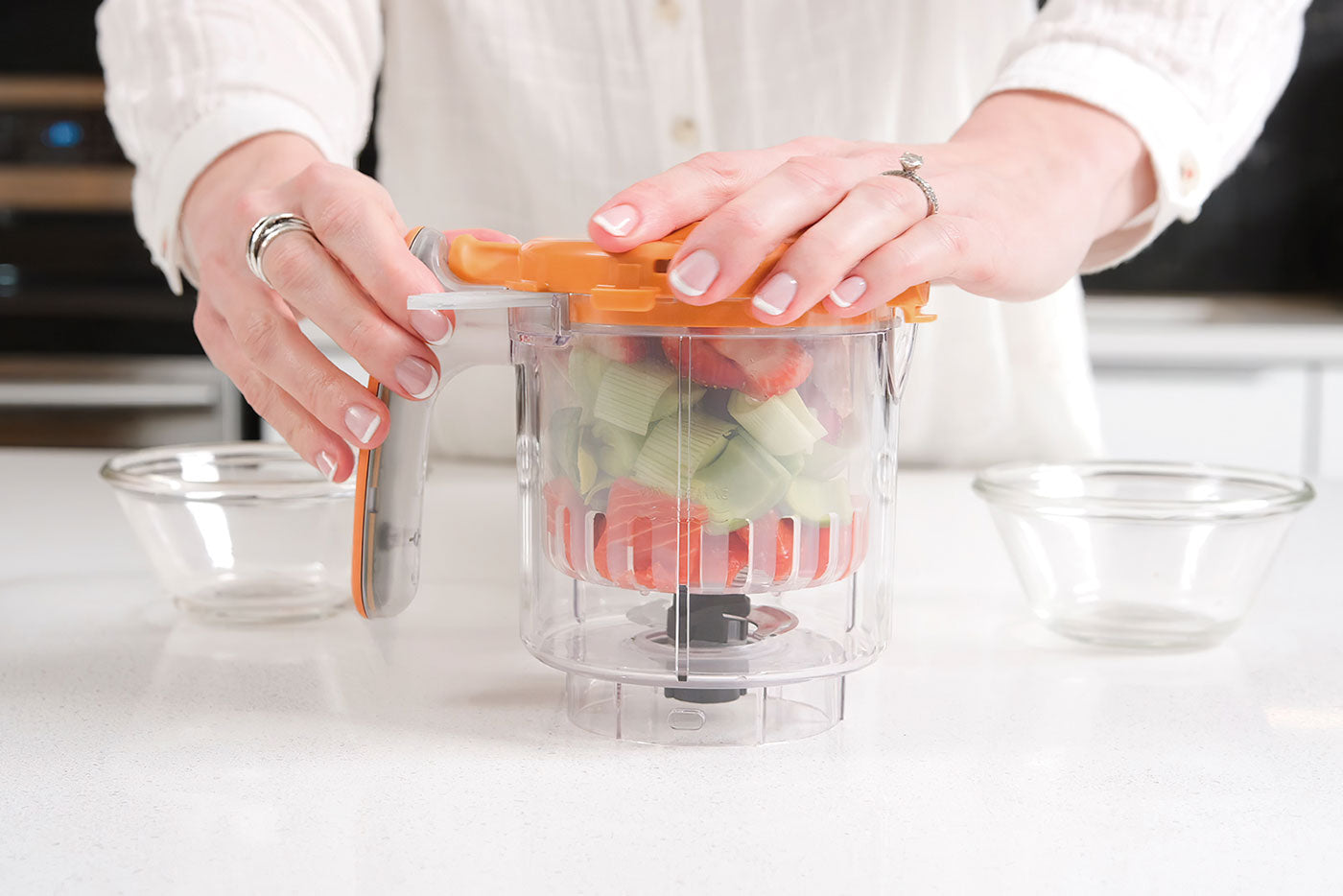 Quark Baby food processor with fresh vegetables and strawberries for homemade baby food preparation.