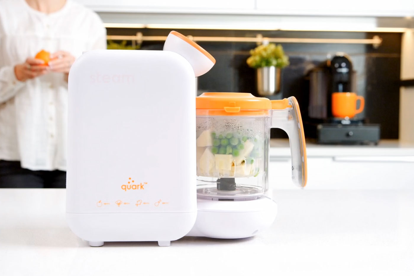Quark Baby Quook baby food processor with parsnip and pea purée recipe preparation in kitchen.
