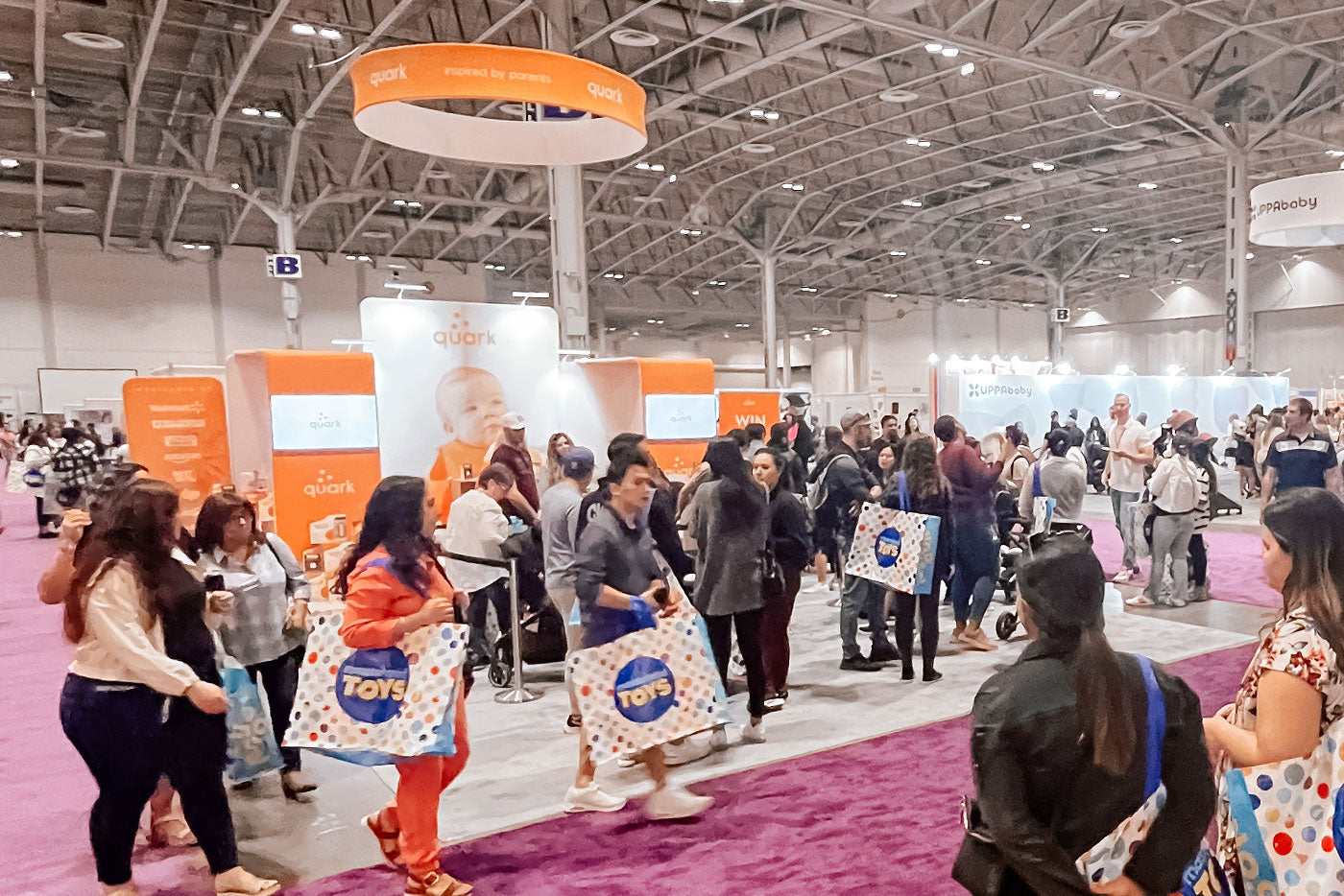 Quark Baby booth at The Baby Show Vancouver with BuubiBottle hybrid feeding bottles and branded merchandise displays.