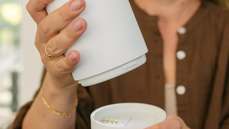 The removable stainless steel vessel of the BuubiBottle Portable Milk Warmer PRO lifted from its base
