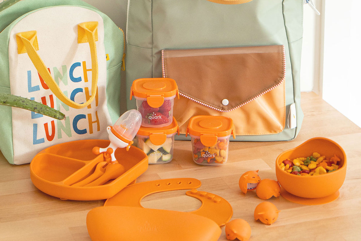Quark Baby orange feeding set with lunch bag, containers, plate, and utensils for toddlers.